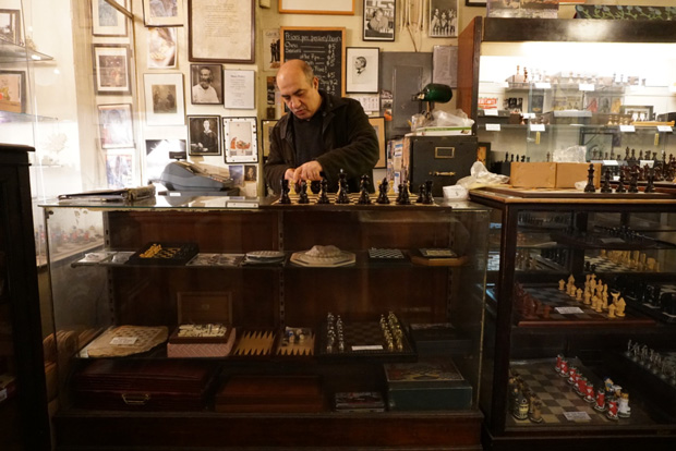 Imad Khachan behind the counter of his West Village chess shop. Khachan opened the Chess Forum in 1995 after a bitter feud with his business mentor. Photo credit: Neil Giardino