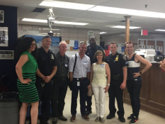 Greenwich Village-Chelsea Chamber of Commerce members posing for a photo with Sixth Precinct officers, including Maria Diaz, G.V.C.C. executive director, at far left; Ken Russo, fourth from left; Rocio Sanz, third from right; and Mathew Heggem, far right.